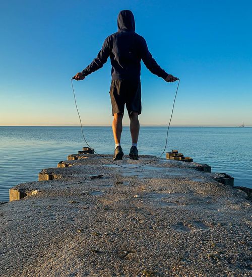 Person stretching outdoors at sunrise, embodying vitality and wellness.