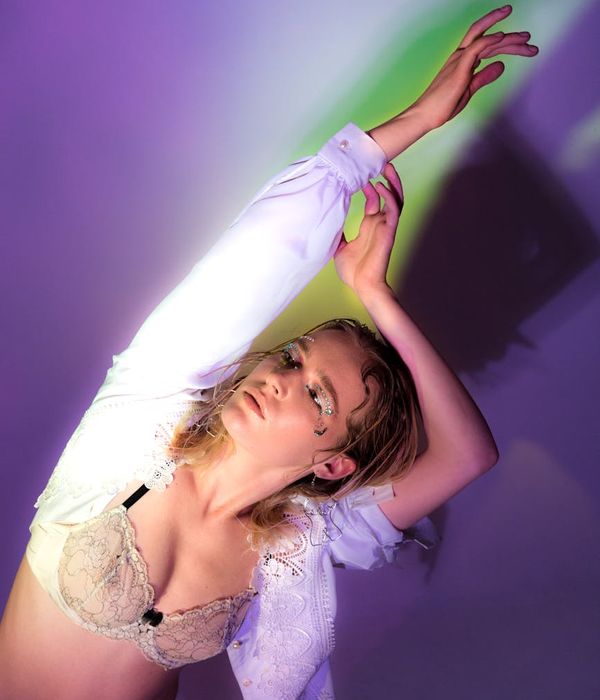 Woman in a dynamic yet graceful pose, suggesting energy and movement.